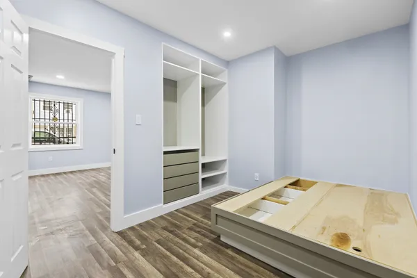 a bedroom with a bed and cabinets