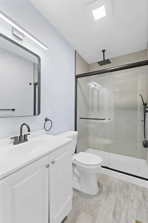 a bathroom with a sink a toilet and a mirror