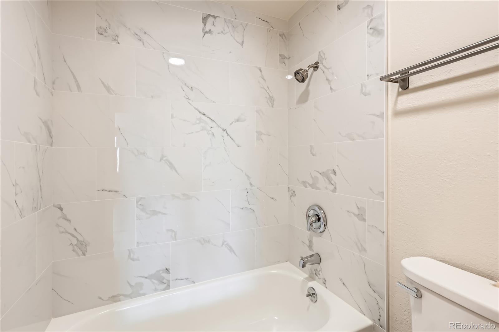 1302 South Parker Road, Unit 229 Denver, CO 80231 - Photo 7 of 18 a bathroom with a bathtub and shower