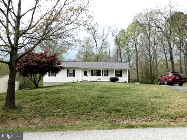 5013 Decatur Street St. Leonard, MD 20685 - Photo 3 of 45 a front view of a house with a garden