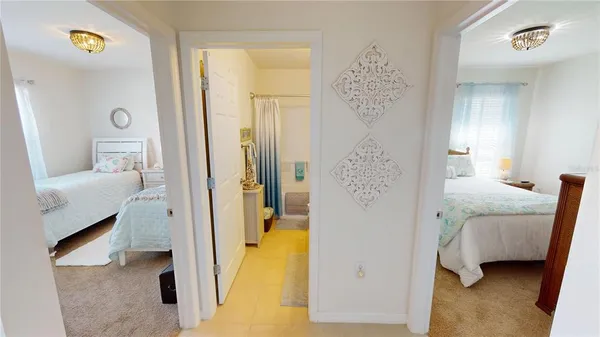 a bedroom with a bed and a painting on the wall