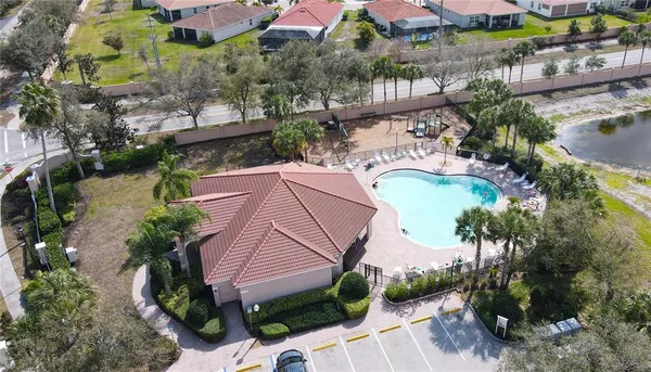 an aerial view of a house with a yard and potted plants