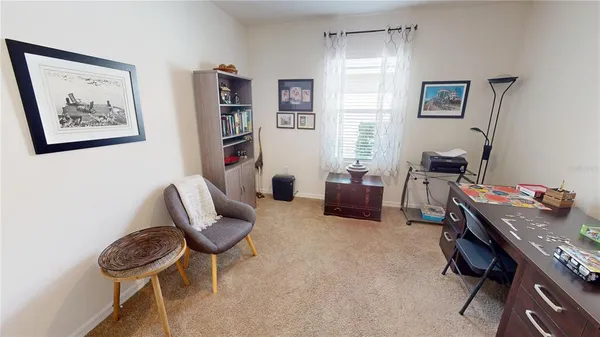 a bedroom with a workspace and a couch