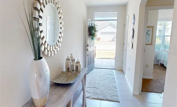 a living room with furniture a flat screen tv and a window