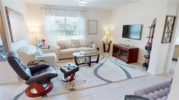 a living room with furniture and kitchen view