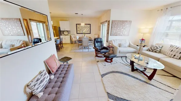 a living room with furniture a flat screen tv and a sink