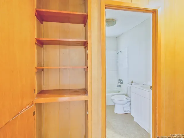 a bathroom with a toilet shower and a sink