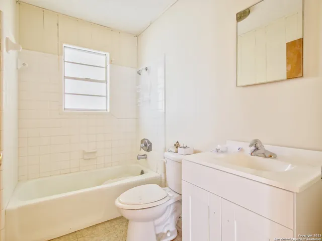 a bathroom with a sink mirror toilet and bathtub