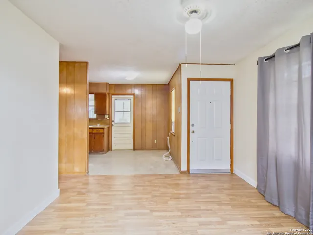 a view of a kitchen with a refrigerator and a stove top oven