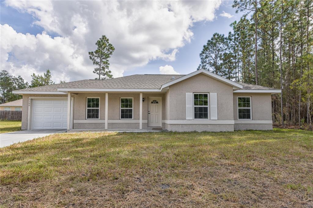 247 Malauka Loop Ocklawaha, FL 32179 - Photo 1 of 1 a front view of a house with a garden