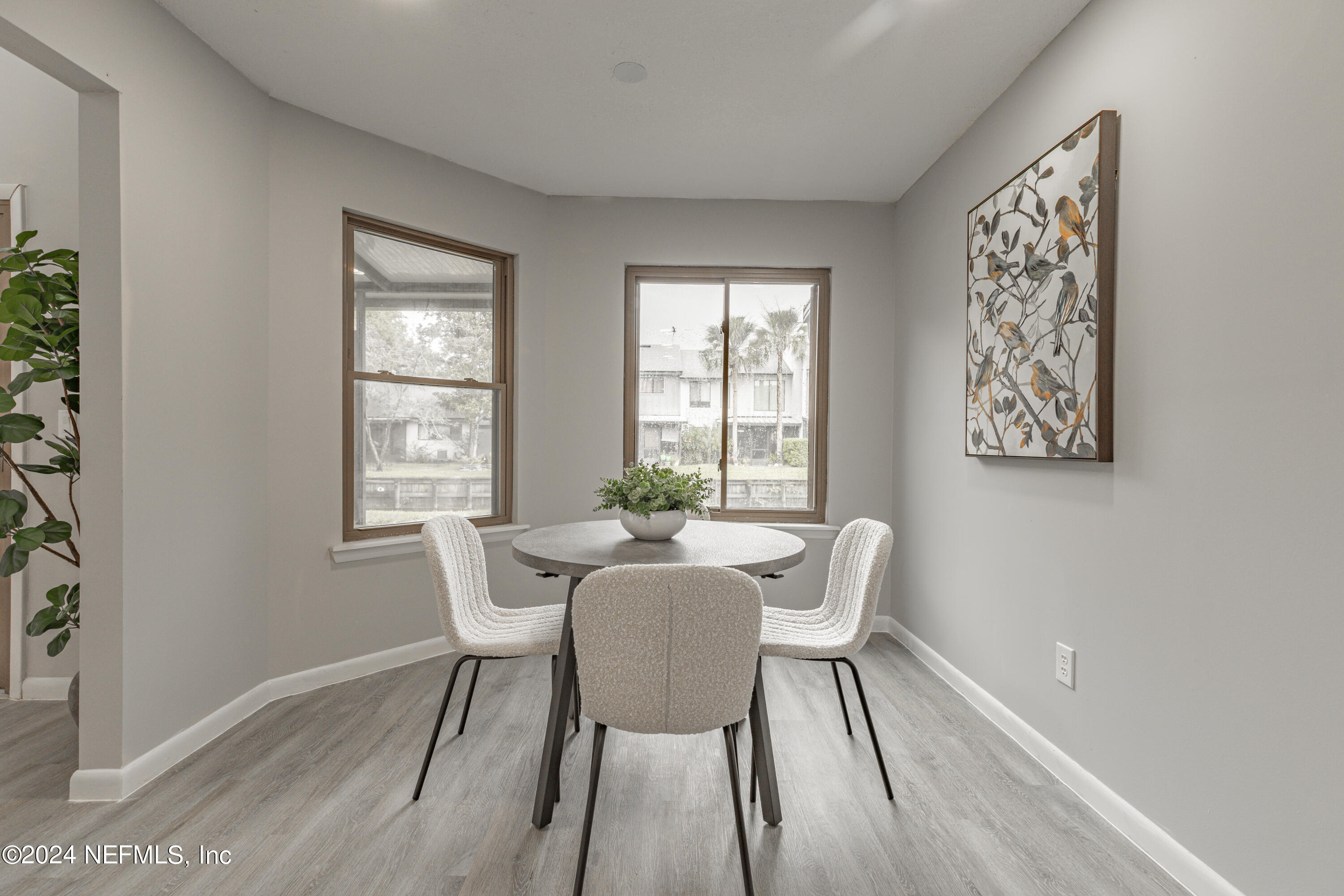 9360 Craven Road, Unit 504 Jacksonville, FL 32257 - Photo 11 of 28 a view of a dining room with furniture and wooden floor