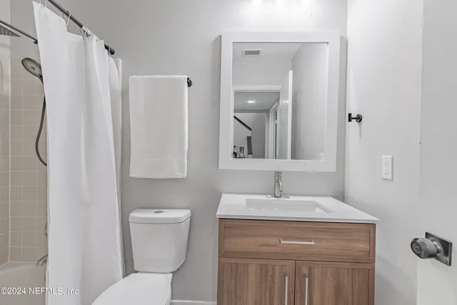 a bathroom with a toilet sink and shower