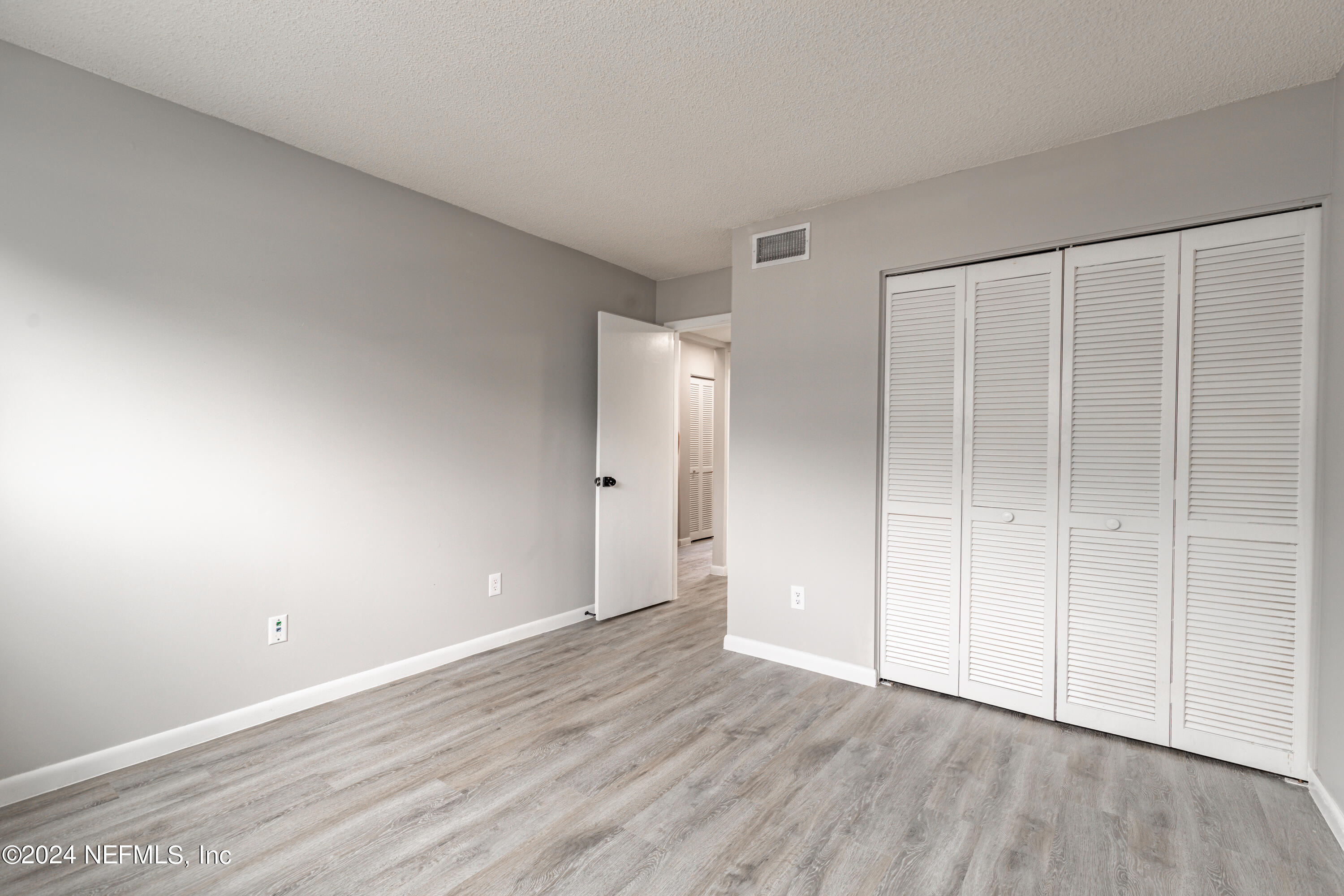 9360 Craven Road, Unit 504 Jacksonville, FL 32257 - Photo 15 of 28 a view of an empty room with wooden floor