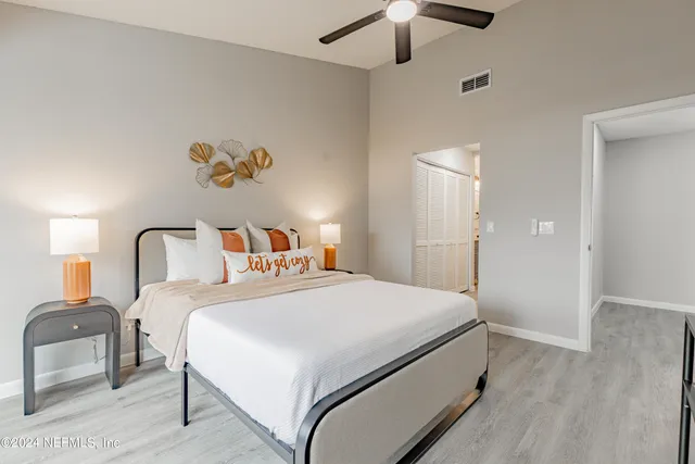 a bedroom with a bed and a chandelier