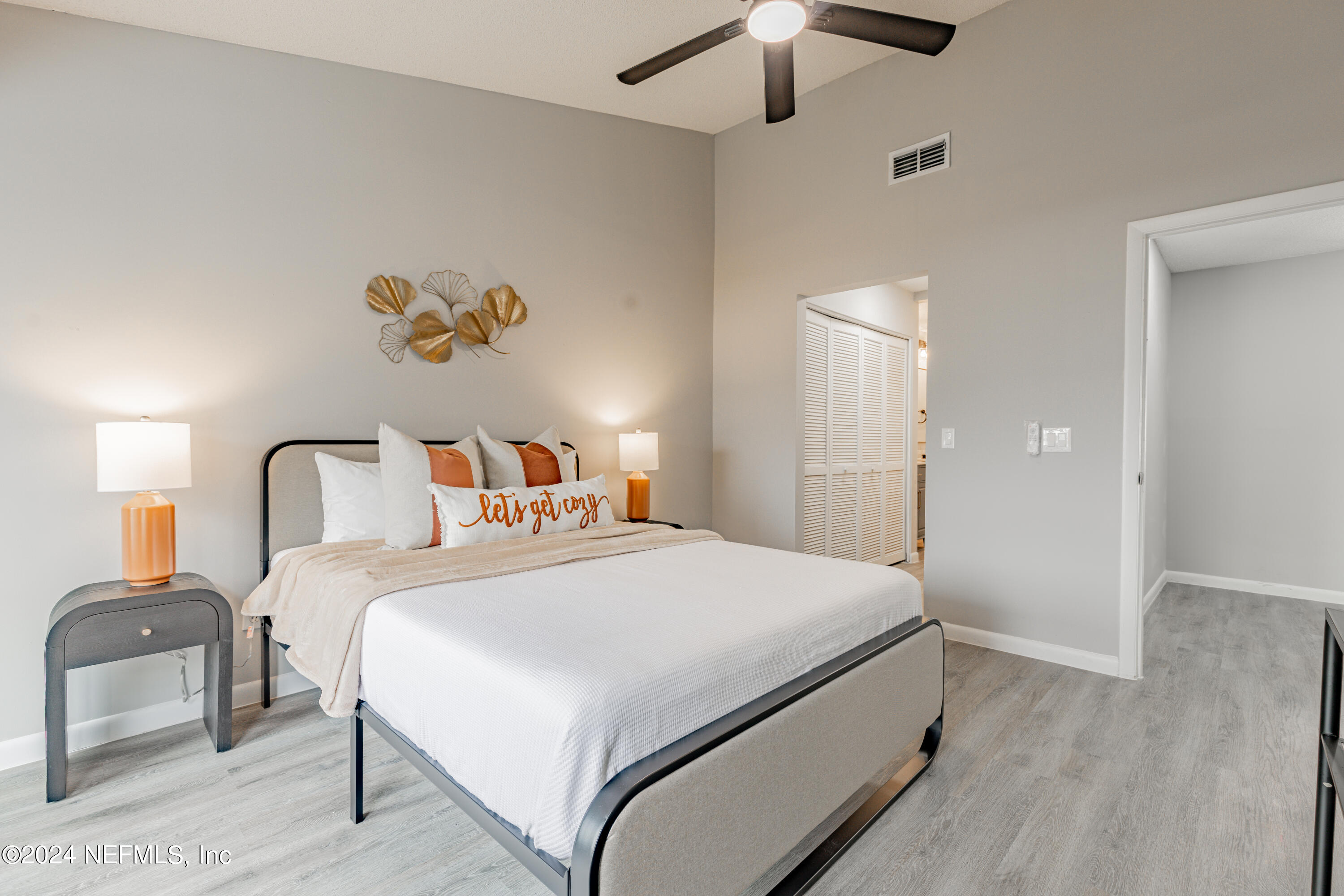 9360 Craven Road, Unit 504 Jacksonville, FL 32257 - Photo 17 of 28 a bedroom with a bed and a chandelier