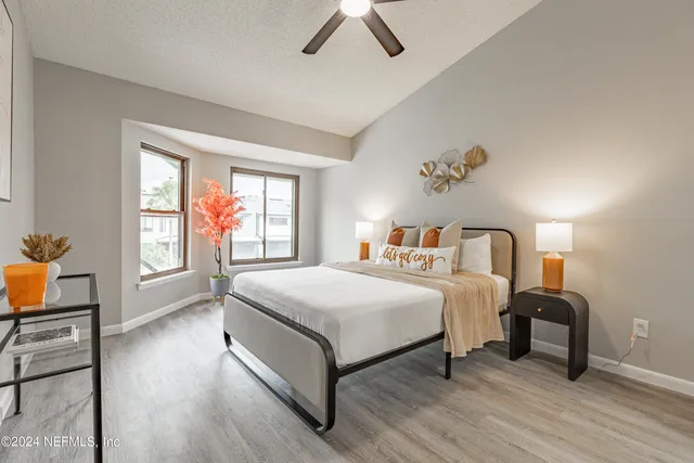 a bedroom with a bed and wooden floor