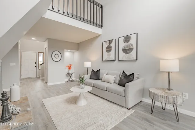 a living room with furniture and a lamp