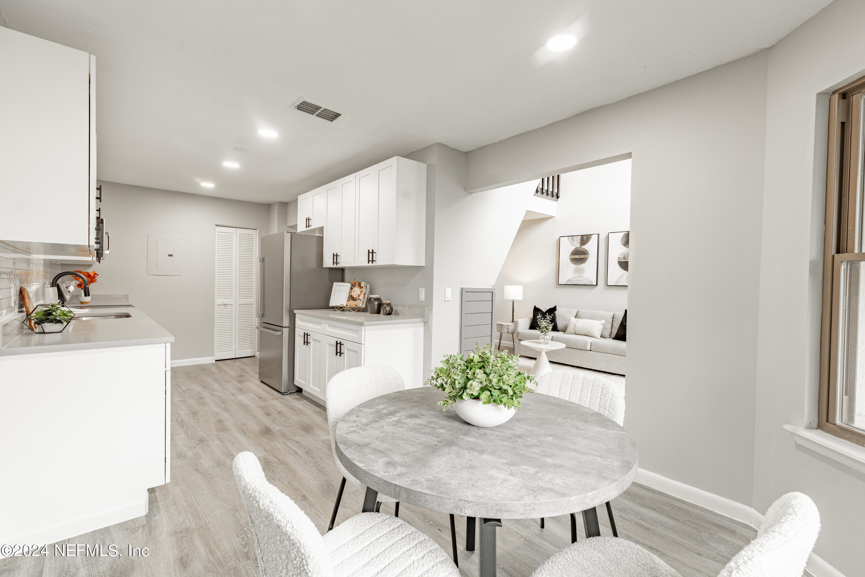 9360 Craven Road, Unit 504 Jacksonville, FL 32257 - Photo 10 of 28 a kitchen with a dining table chairs and refrigerator