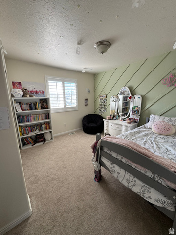 36 North Trailside Road West Farmington, UT 84025 - Photo 7 of 15 Spacious bedroom featuring neutral carpeting, built-in shelving with ample storage, a vanity with attached mirror and lighting, and large window with plantation shutters providing natural light