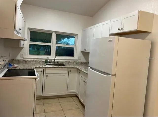 a white refrigerator freezer sitting inside of a kitchen