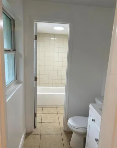 a bathroom with a toilet and a bathtub