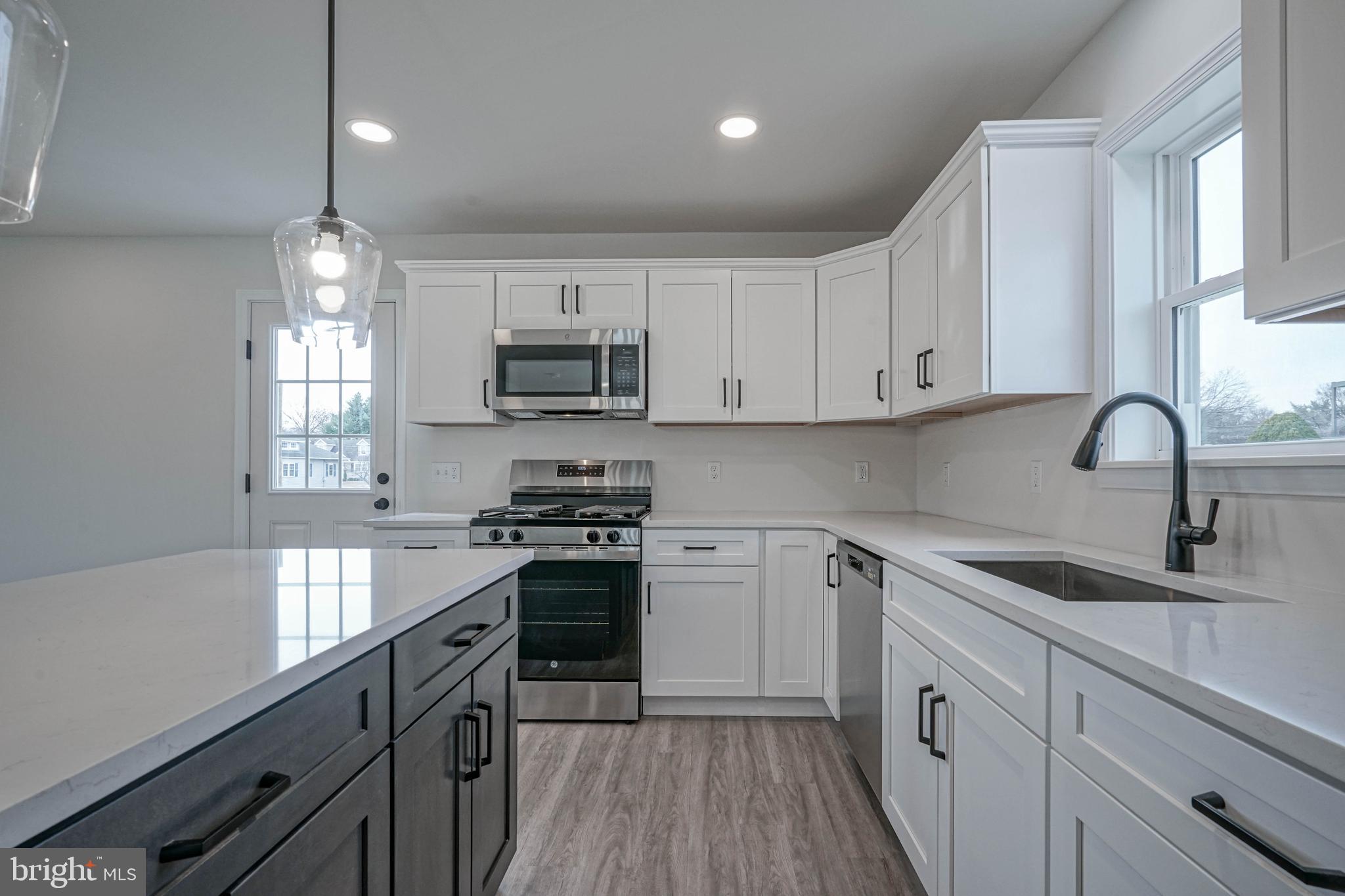 5 Myrtle Avenue Gloucester City, NJ 08030 - Photo 23 of 51 a kitchen with kitchen island granite countertop a sink stainless steel appliances and cabinets