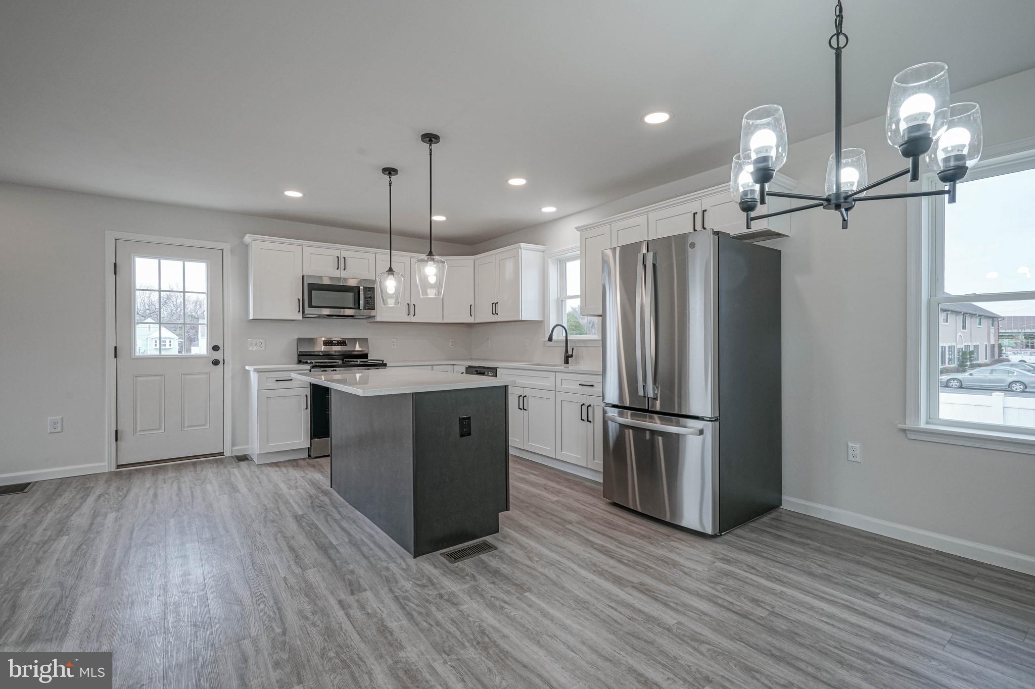 5 Myrtle Avenue Gloucester City, NJ 08030 - Photo 25 of 51 a kitchen with stainless steel appliances granite countertop a refrigerator a sink dishwasher a stove and a refrigerator with wooden floor