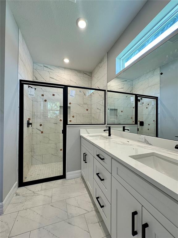 13081 Southwest 78th Circle Ocala, FL 34473 - Photo 11 of 22 a bathroom with a granite countertop sink mirror and shower