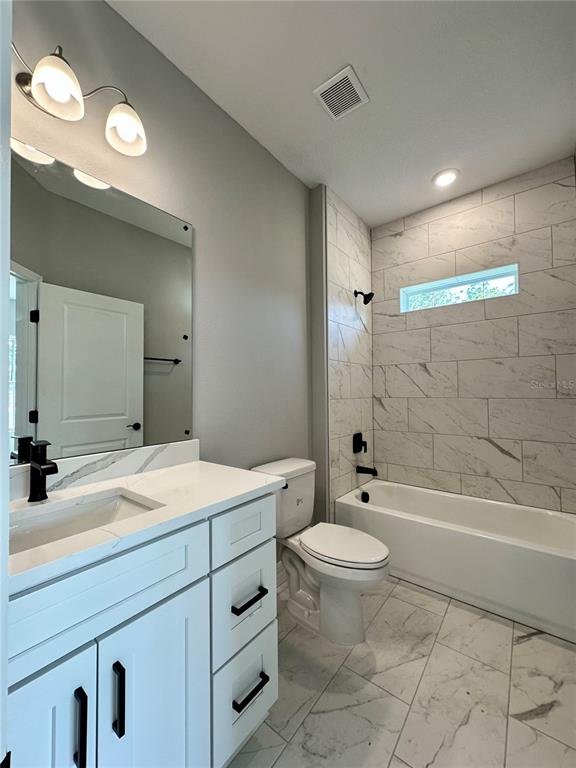 13081 Southwest 78th Circle Ocala, FL 34473 - Photo 16 of 22 a bathroom with a sink a toilet and shower