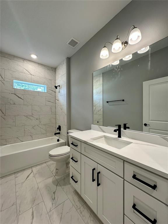 13081 Southwest 78th Circle Ocala, FL 34473 - Photo 19 of 22 a bathroom with a sink a toilet and bathtub