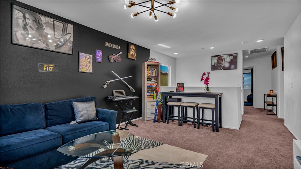 2271 Linden Lane Banning, CA 92220 - Photo 11 of 38 a living room with furniture a flat screen tv and a dining table