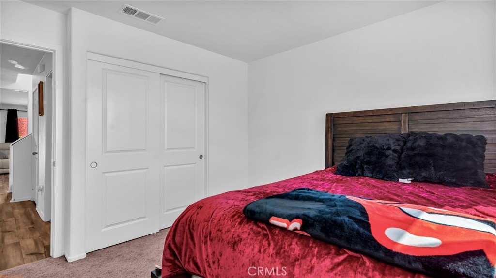 2271 Linden Lane Banning, CA 92220 - Photo 12 of 38 a bedroom with a bed and a mirror