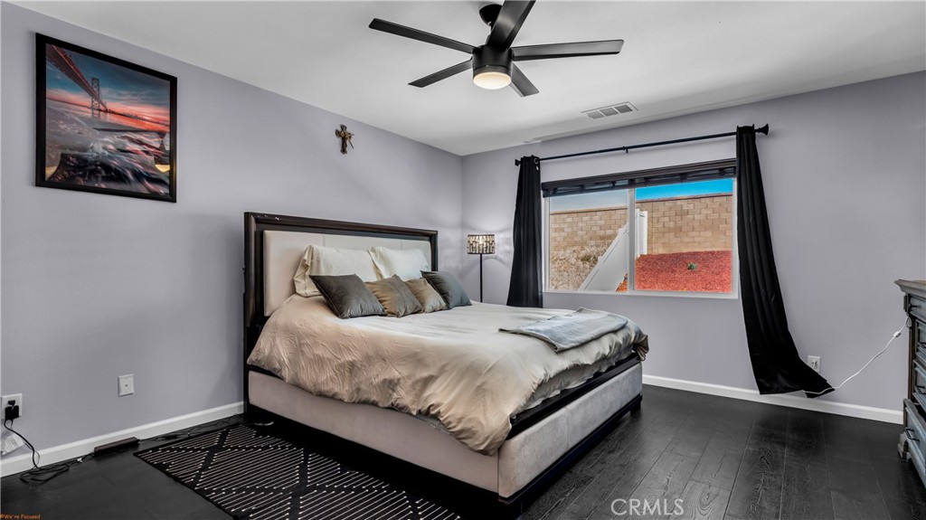 2271 Linden Lane Banning, CA 92220 - Photo 17 of 38 a bedroom with a bed and wooden floor