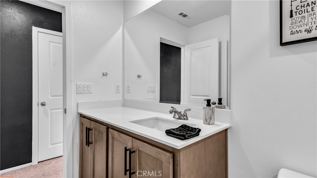 2271 Linden Lane Banning, CA 92220 - Photo 22 of 38 a bathroom with a sink and a mirror
