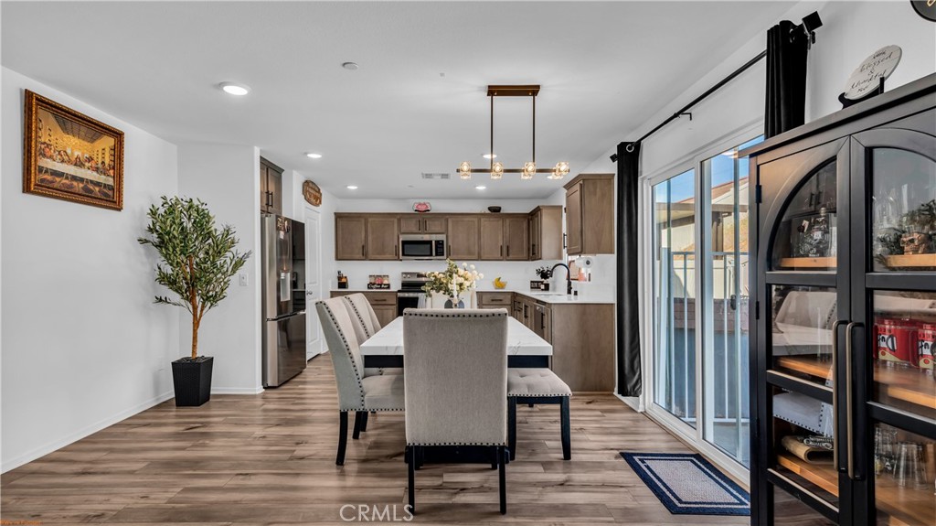 2271 Linden Lane Banning, CA 92220 - Photo 5 of 38 a view of a dining room with furniture window and wooden floor