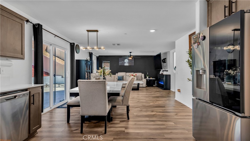 2271 Linden Lane Banning, CA 92220 - Photo 7 of 38 a view of a dining room with furniture window and wooden floor