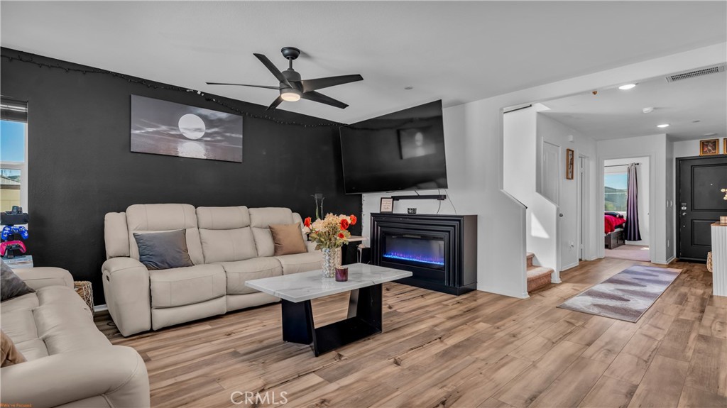 2271 Linden Lane Banning, CA 92220 - Photo 8 of 38 a living room with furniture a fireplace and a flat screen tv