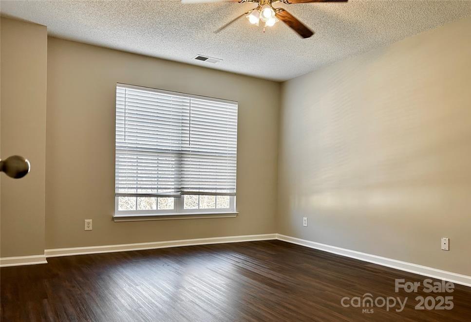 1021 Meadowbrook Lane Southwest Concord, NC 28027 - Photo 11 of 19 an empty room with wooden floor and windows