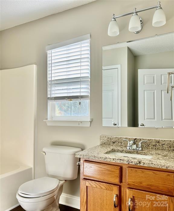 1021 Meadowbrook Lane Southwest Concord, NC 28027 - Photo 12 of 19 a bathroom with a granite countertop sink a toilet and a mirror