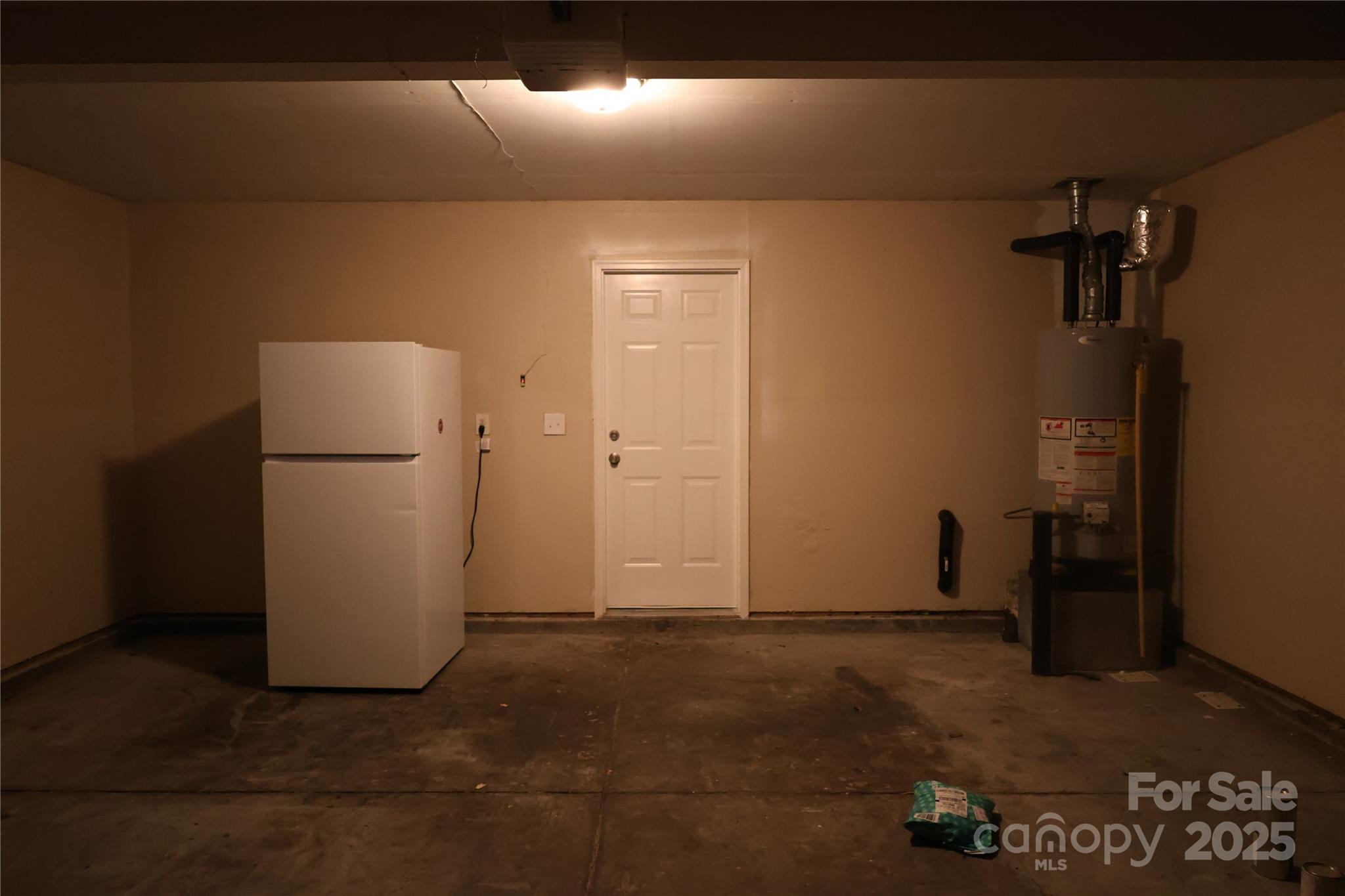 1021 Meadowbrook Lane Southwest Concord, NC 28027 - Photo 16 of 19 a view of a refrigerator in kitchen and an empty room