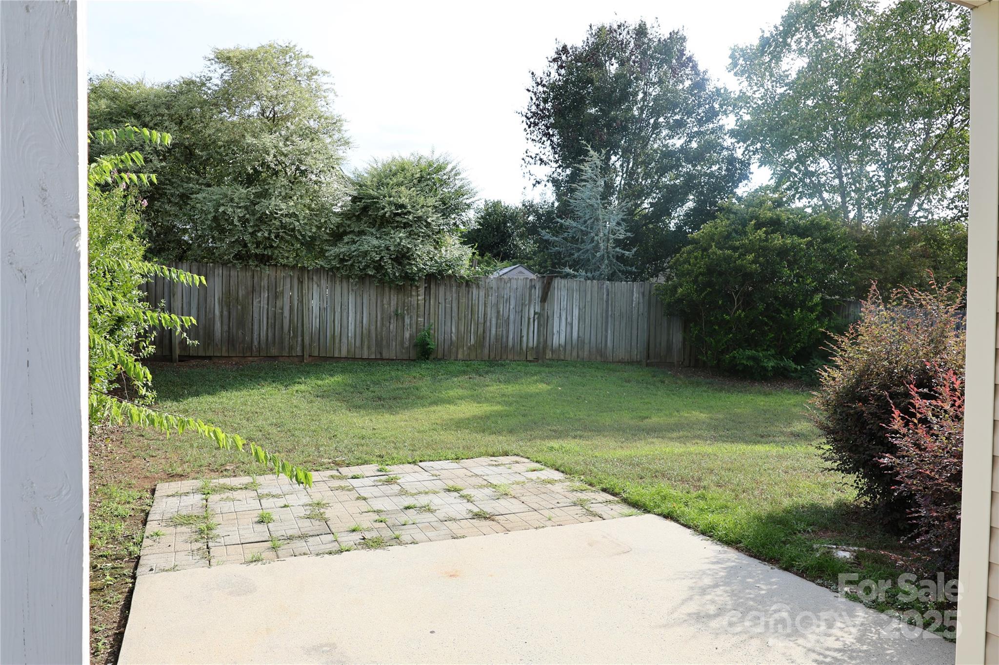 1021 Meadowbrook Lane Southwest Concord, NC 28027 - Photo 19 of 19 a view of a backyard with potted plants and large tree