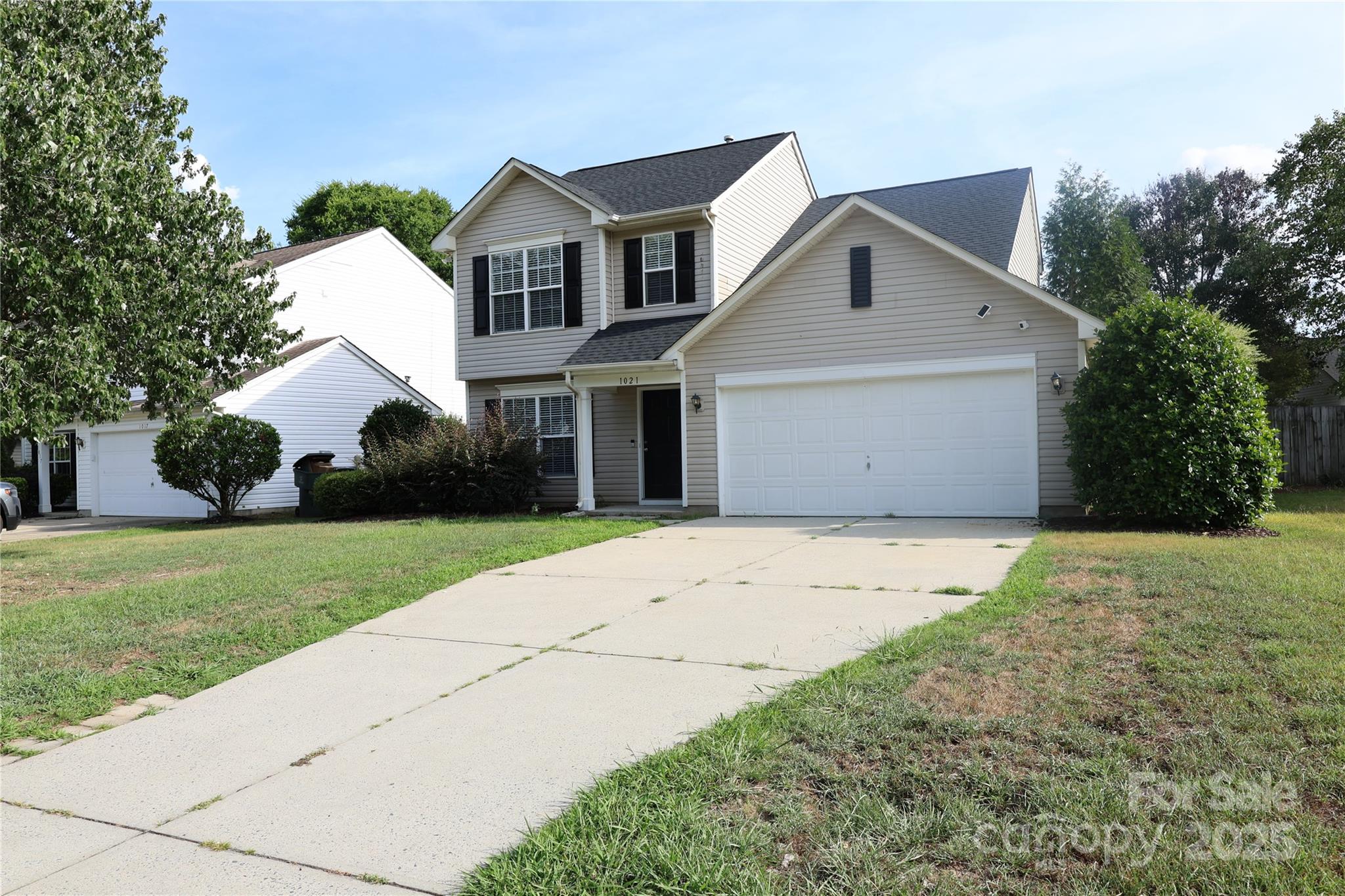 1021 Meadowbrook Lane Southwest Concord, NC 28027 - Photo 3 of 19 a front view of a house with a garden