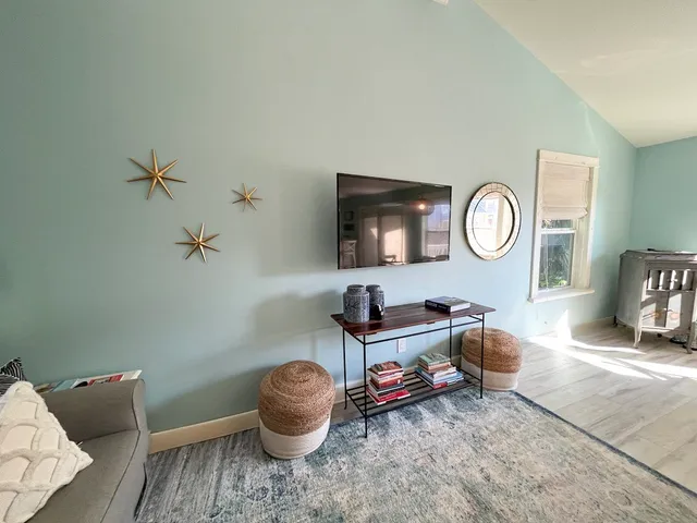 a living room with furniture and a mirror