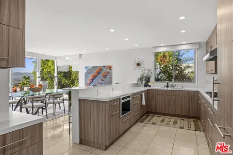 a spacious bedroom with a bed and glass door