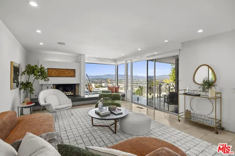 a view of a chairs and table in a balcony