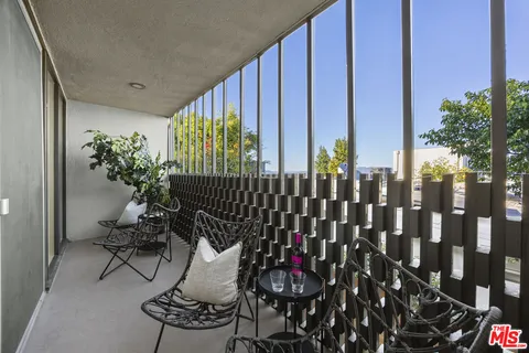 a view of balcony with furniture