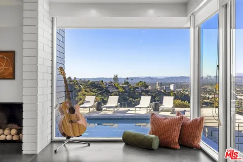 a view of a living room with furniture and a floor to ceiling window