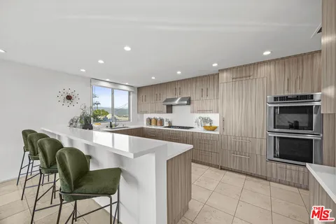 a living room with fireplace furniture and a large window