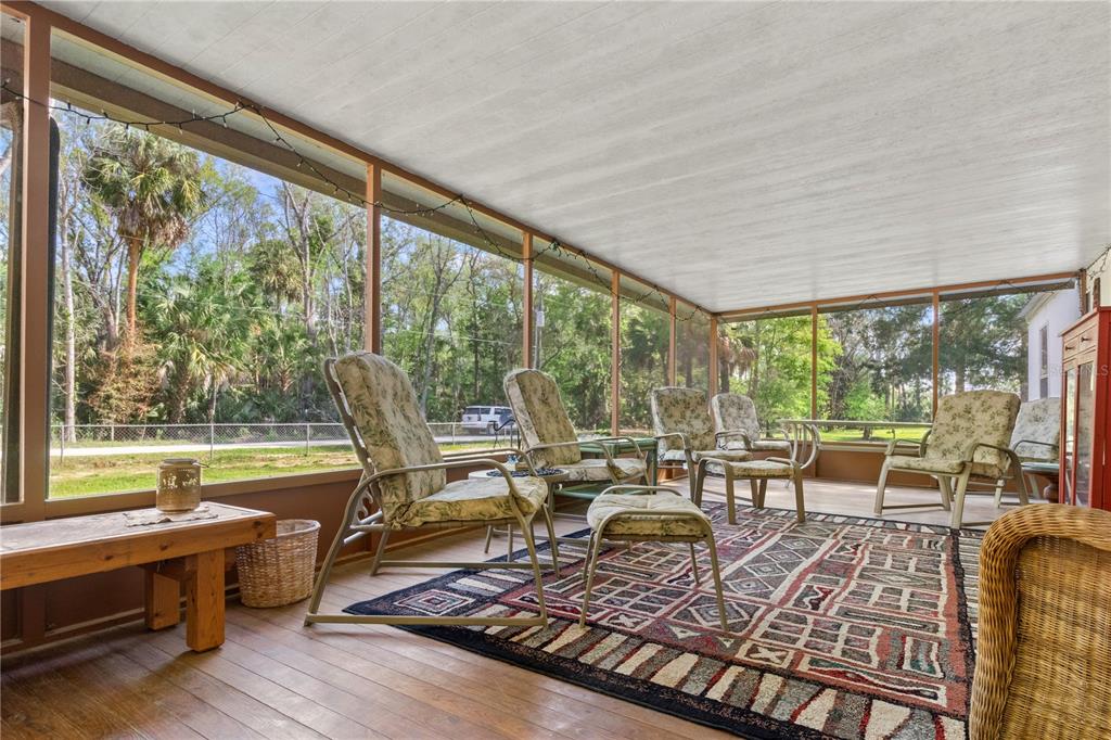 3650 176 Place Inglis, FL 34449 - Photo 12 of 49 a living room with furniture tv and large windows