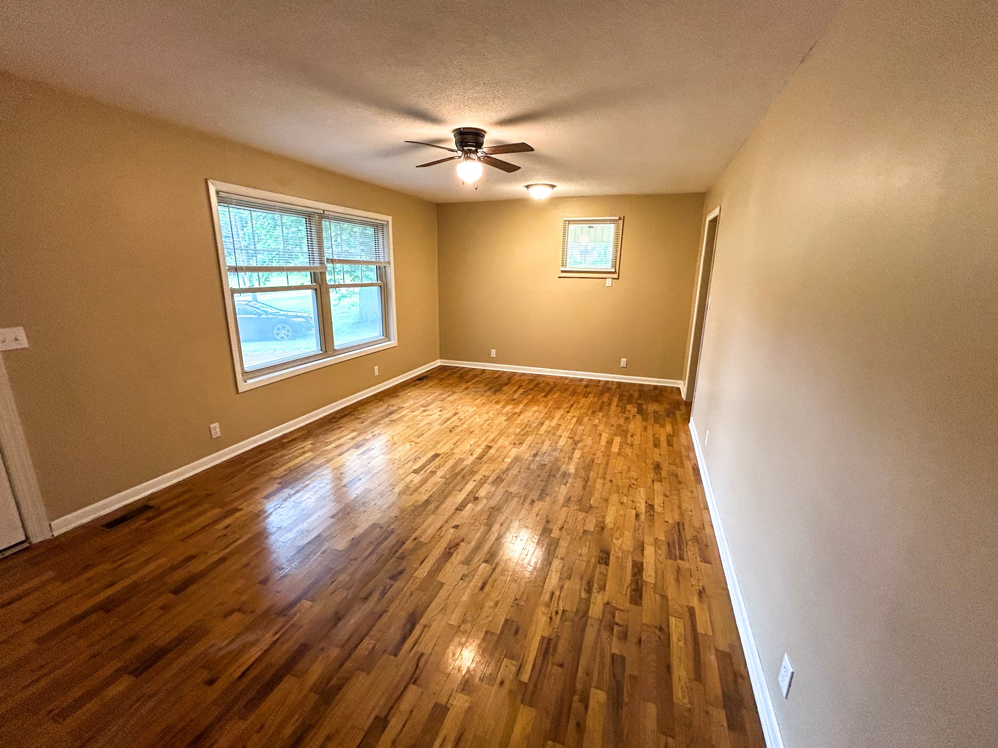 181 Jones Street Huntingdon, TN 38344 - Photo 11 of 21 a view of an empty room with wooden floor and a window